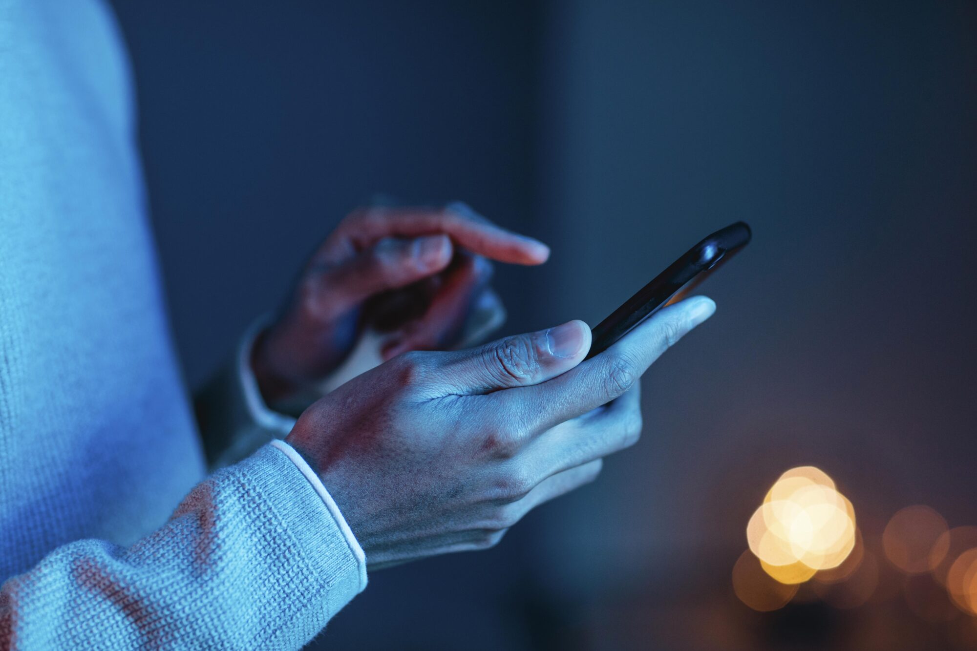 Person using a phone to contact Quadro Dental