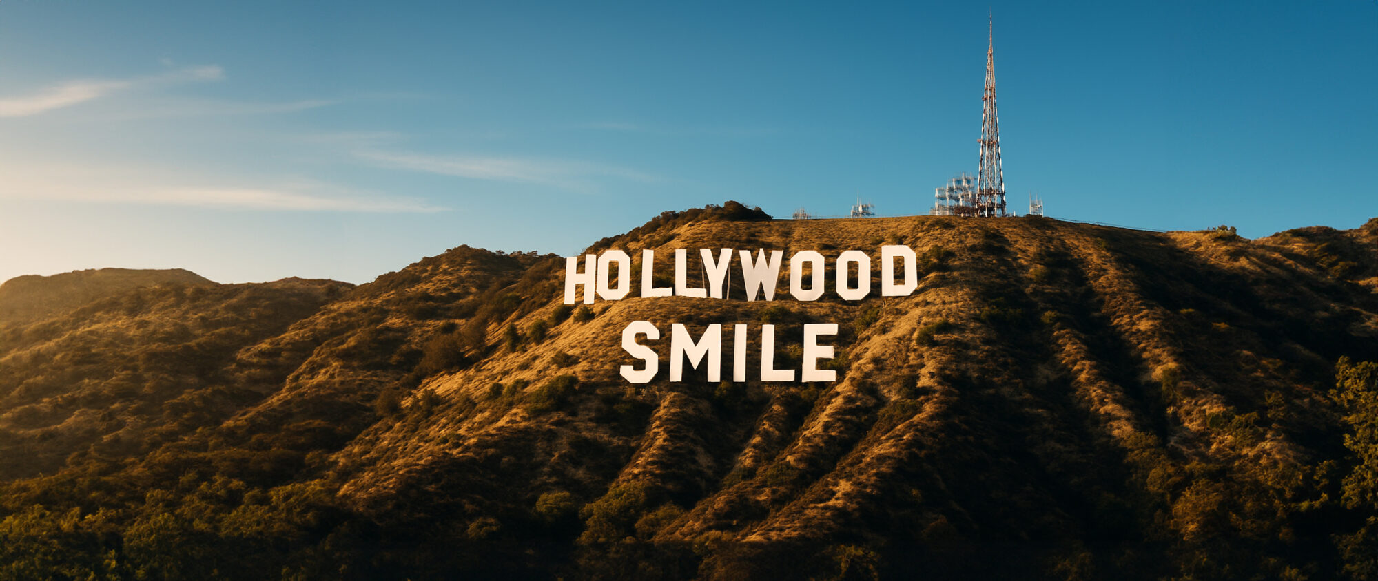 Hollywood sign with the word “Smile” added beneath it, representing aesthetic smile transformations in Turkey