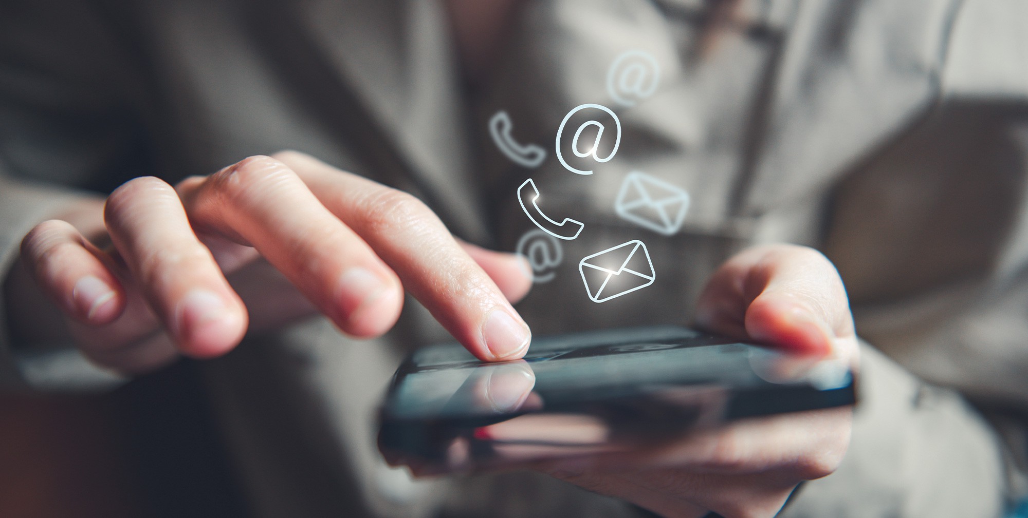 Hand holding phone with contact icons for Quadro Dental dental services